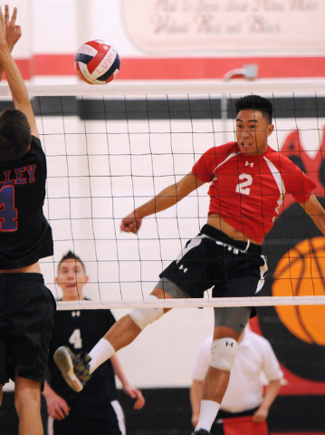 Las Vegas’ T.J. Esporas (2) spikes the ball over Valley’s Alex Sandoval (4) duri ...