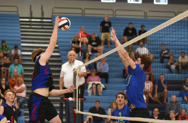 Valley’s Noah Sutton (17) spikes the ball against Green Valley’s Chase Larson (1 ...