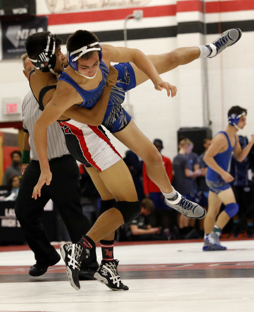 Las Vegas’s Aaron Najera lifts Basic’s Nick Ortiz during a 138 pounder match at ...