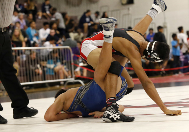 Las Vegas’s Aaron Najera, top, wrestles Basic’s Nick Ortiz during a 138 pounder ...