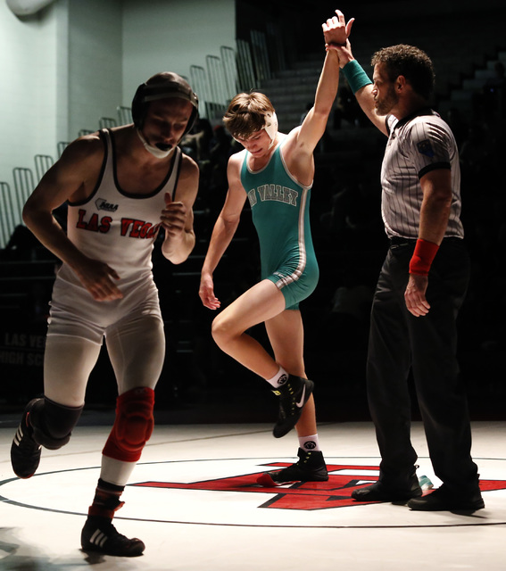 Green Valley’s Justus Scott, green singlet, hand is raised as Las Vegas’s Daniel ...