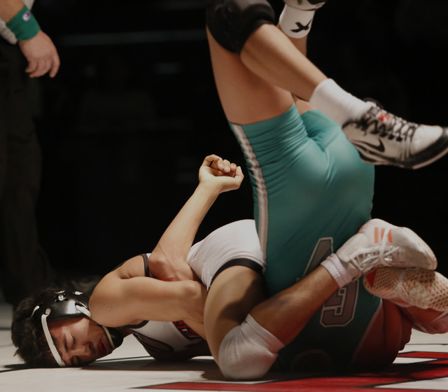 Las Vegas’s Antonio Saldate, white singlet, attempts to pin Green Valley’s David ...