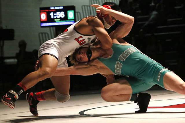 Las Vegas’s Jaesen Caday, left, sprawls as Green Valley’s Wallace Zernich shoots ...