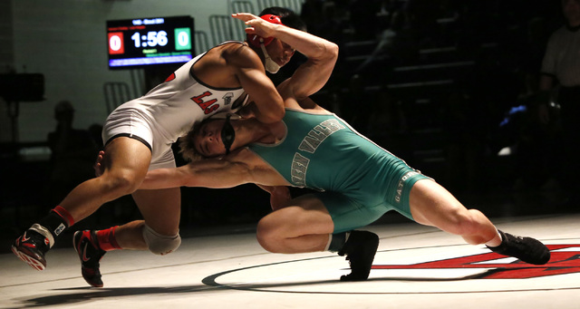 Las Vegas’s Jaesen Caday, left, sprawls as Green Valley’s Wallace Zernich shoots ...