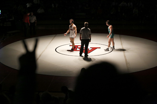 A fan signals to a referee to award Green Valley’s Cody Chamblerlin, right, two points ...