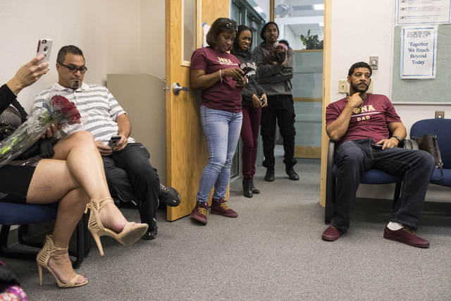 Family members wait for signing day to begin at Centennial High School in Las Vegas on Wedne ...