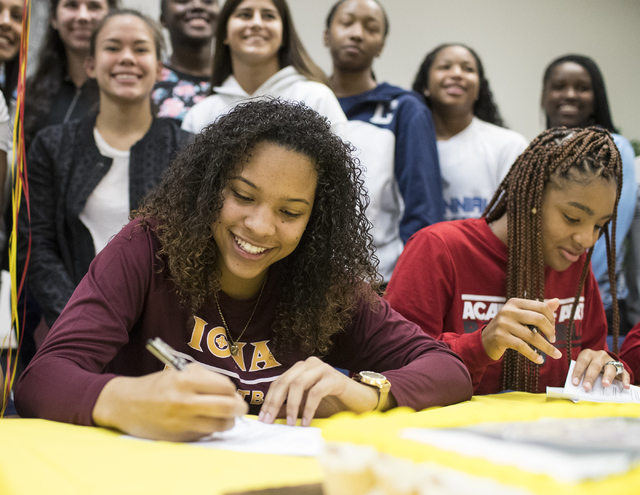 Jayden Eggleston, left, and Megan Jefferson sign a letter of intent at Centennial High Schoo ...