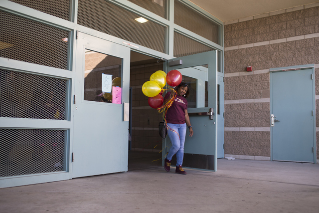 Camisha Gathright, mother of Jayden Eggleston, leaves signing day at Centennial High School ...