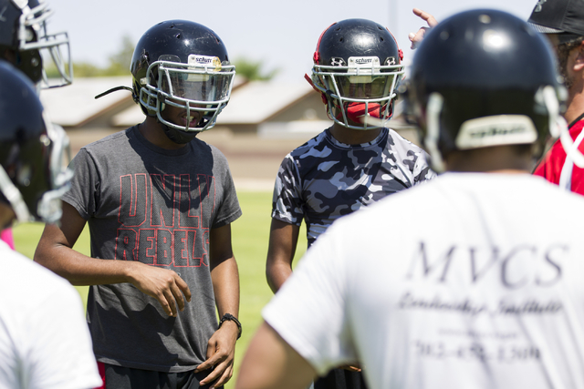 Tyrell Brooks, left, 16, and his twin brother Terrence, attend a team football practice at M ...