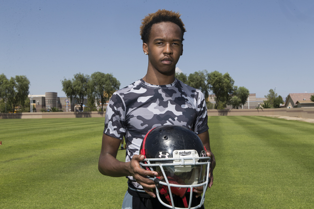 Terrence Brooks, left, 16, is photographed during a team football practice at Mountain View ...