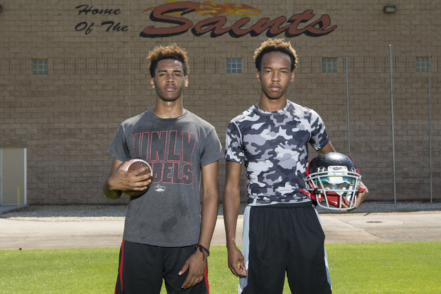 Tyrell Brooks, left, 16, is photographed with his twin brother Terrence during a team footba ...