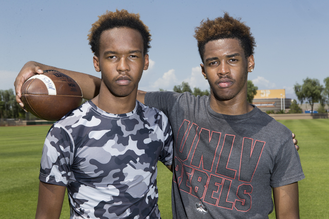 Terrence Brooks, left, 16, is photographed with his twin brother Tyrell during a team footba ...