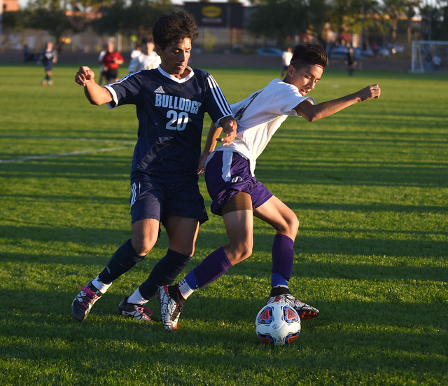 Centennial’s Jesus Vargas (20) battles for the ball against Durango’s Christophe ...