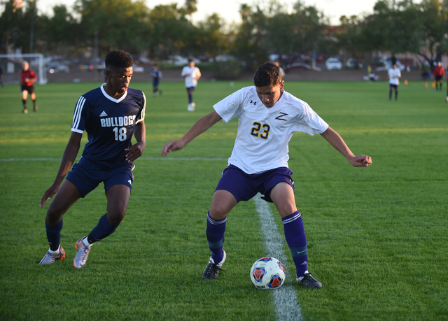 Durango’s Alfredo Robles-Rodriguez (23) battles for the ball against Centennial’ ...