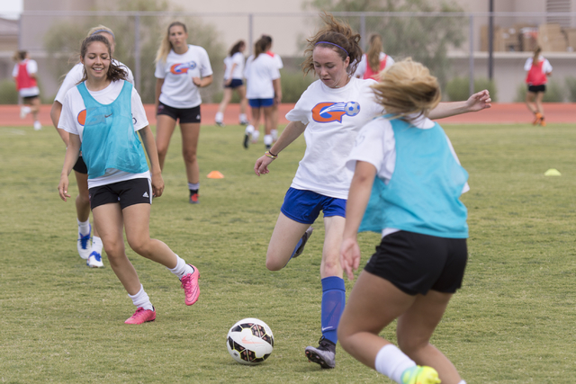 Hannah Borgel (24), center, kicks the ball during girls soccer practice at Bishop Gorman Hig ...