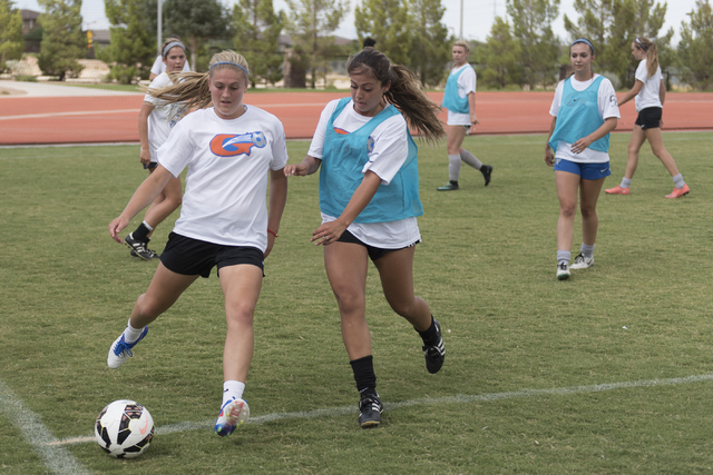 Arlie Jones (51), left, kicks the ball during girls soccer practice at Bishop Gorman High Sc ...