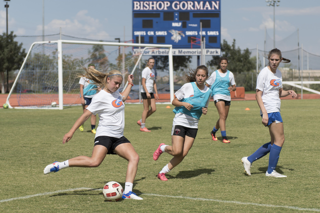 Arlie Jones (51), left, kicks the ball during girls soccer practice at Bishop Gorman High Sc ...