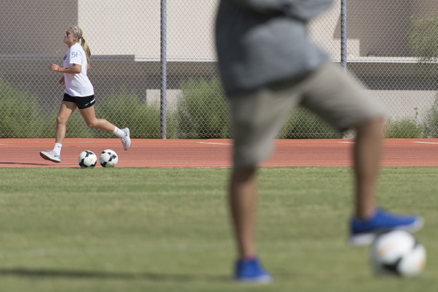 Arlie Jones (51), runs around the track during girls soccer practice at Bishop Gorman High S ...