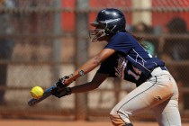 Centennial base second baseman Kiana Tate lays down a successful bunt against Brawley (Calif ...