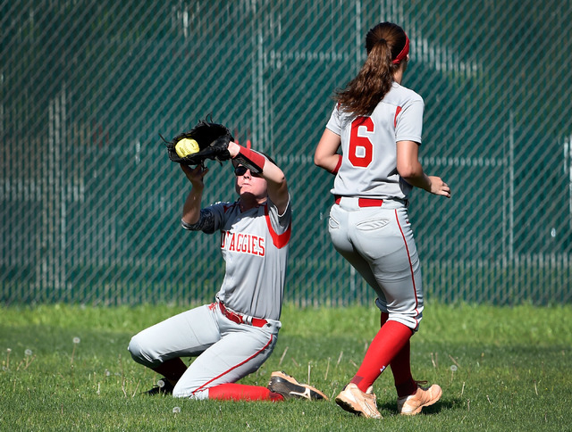 Arbor View center fielder Brittany Henricksen grabs a fly ball as Sarah Bradford looks on du ...