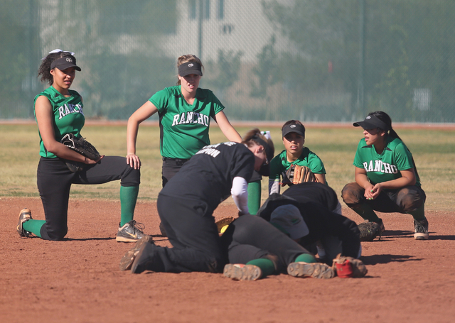 Rancho girls take a knee as injured teammate Tiare Lee, front center, is tended to during a ...