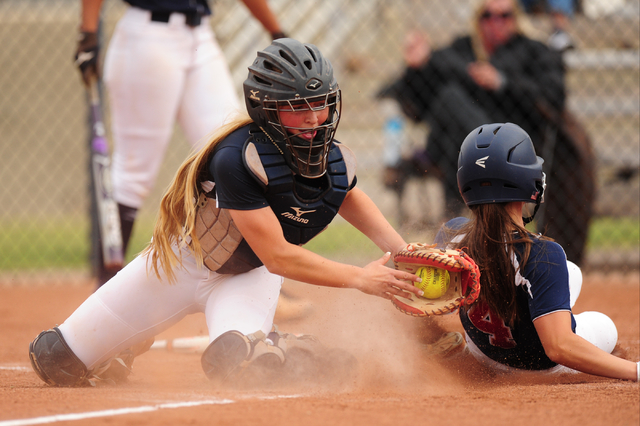 Coronado base runner Dylan Underwood scores a run while Foothill catcher Haleigh Olive field ...