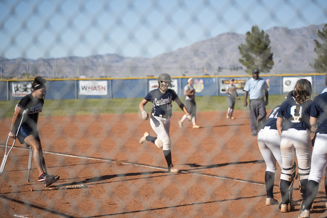 Centennial’s Ava Dolan (16) runs to home plate as teammates wait to congratulate her f ...