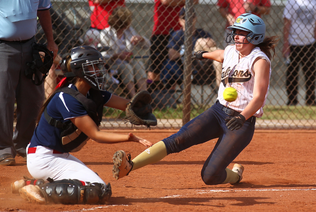 Foothill’s Kelsey McFarland slides safely into home plate as Coronado’s Basia Qu ...