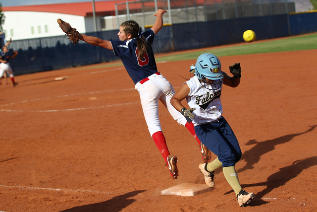 Foothill’s Kiela Lizares (7) makes it safely to first base as the throw sails past Cor ...