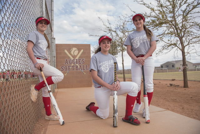 Triplets, from left, Bryce, Brittany and Breanne Henriksen, 16, pose for a portrait at Arbor ...