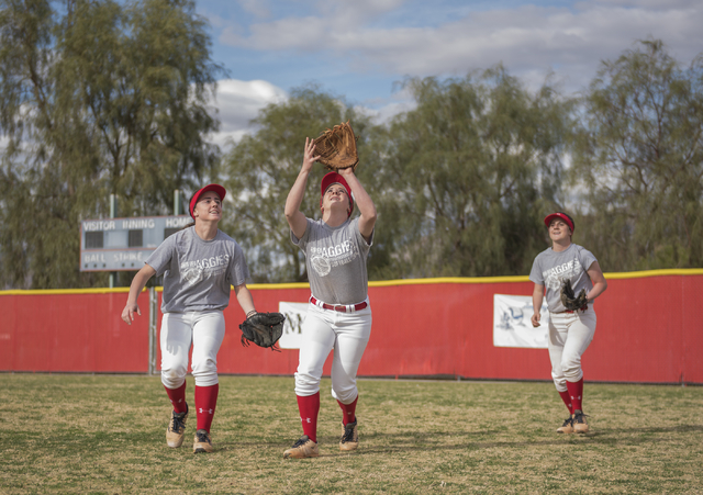 Triplets, from left, Brittany, Breanne and Bryce Henriksen, 16, go after a fly ball during a ...