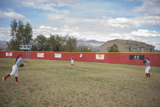 Triplets, from left, Breanne, Bryce and Brittany Henriksen, 16, play catch at Arbor View Hig ...