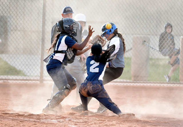 Desert Pines’ Virginia Martinez, right, scores a run against Agassi Prep catcher Jazzl ...