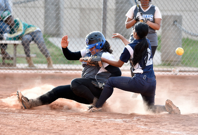 Desert Pines’ Martha Maya slides home against Agassi Prep’s Alizia Hernandez dur ...