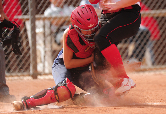 Las Vegas base runner Skylar Gorrell collides with Liberty catcher McKenna Hefley while scor ...