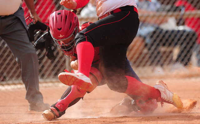 Las Vegas base runner Skylar Gorrell collides with Liberty catcher McKenna Hefley while scor ...