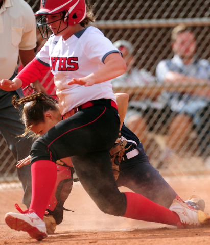 Las Vegas base runner Skylar Gorrell collides with Liberty catcher McKenna Hefley while scor ...