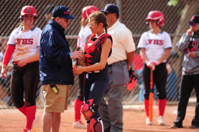 Liberty catcher McKenna Hefley is examined by a trainer after taking a knee to the head duri ...