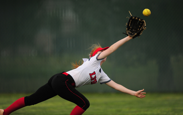 Las Vegas right fielder Cheyenne Porcella is unable to catch a Liberty RBI base hit in the f ...