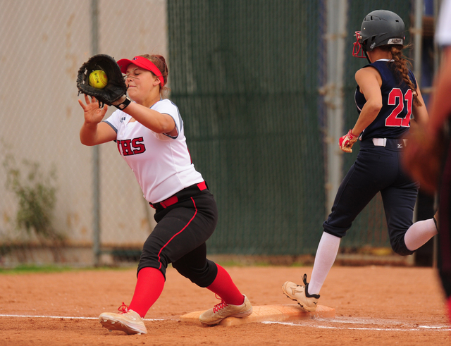 Liberty base runner almost beats out a throw to first base fielded by Las Vegas first basema ...