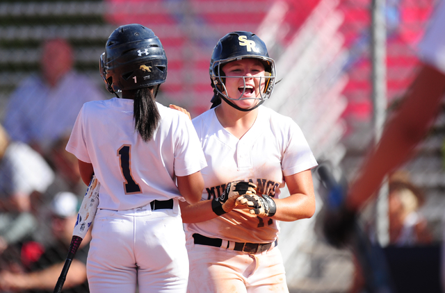 Shadow Ridge base runner Alisha Schultz high fives Samaiya Montgomery (1) after she scored a ...