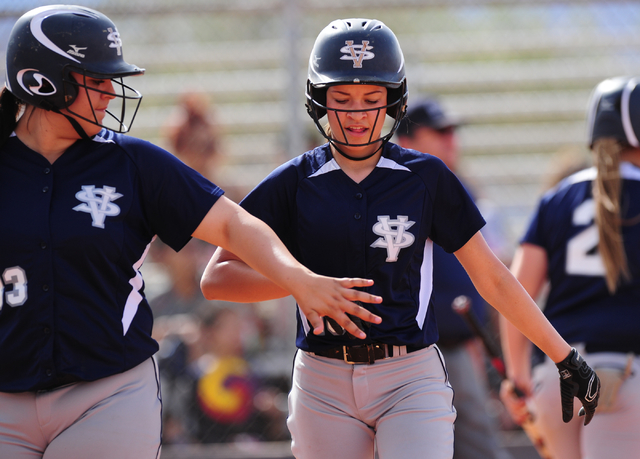 Spring Valley Teegan Teal, center, high fives Raven Bierlein after scoring a run against Sie ...