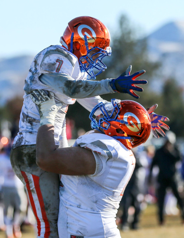 Bishop Gorman’s Biaggio Ali Walsh (7) and Julio Garcia II (74) celebrate a touchdown a ...