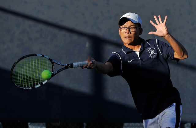 The Meadows’ Kevin Chau returns the ball against Clark’s Michael Pasimio during ...