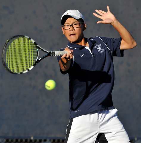 The Meadows’ Kevin Chau returns the ball against Clark’s Michael Pasimio during ...