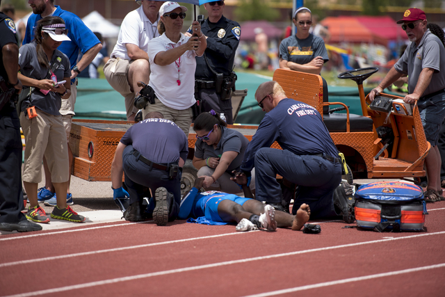 Medical staff tend to Kennedy Adams from Sierra Vista High School after he sustained an inju ...