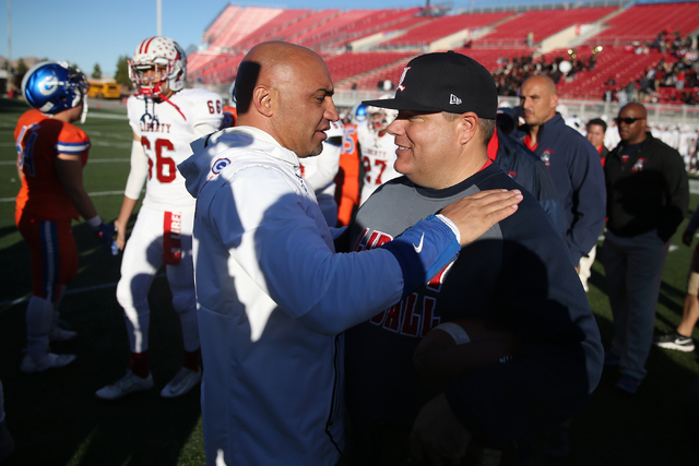 Bishop Gorman’s head football coach Kenny Sanchez, left, and Liberty’s head foot ...