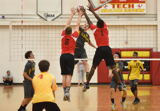 Clark’s Omar Catic (9) spikes the ball against Tech’s Zach Draper (6) and Gary J ...