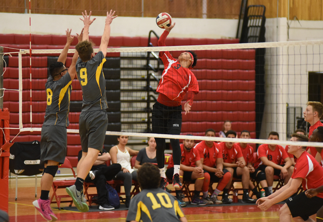 Tech’s Juan Flores (3) spikes the ball against Clark’s Alan Cruz (8) and Omar Ca ...