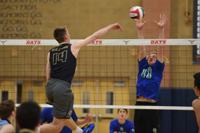 Foothill’s Jonny Rolle (14) spikes the ball against Green Valley’s Tanner Casto ...